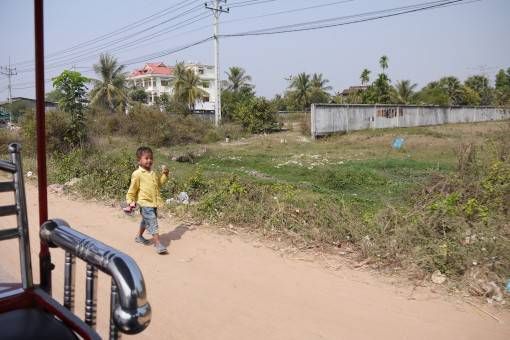 Boy Walking Along the Road in Cambodia