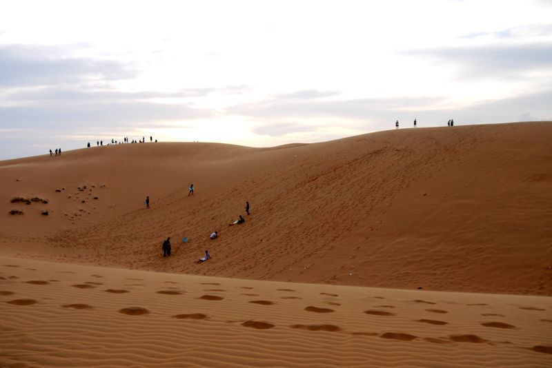 Sand boarders and sunset watchers on the Red Sand Dunes Mui Ne