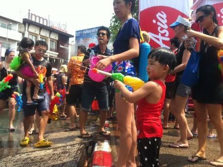 Thai Boy Squirting a Water Pistol During Songkran 2014