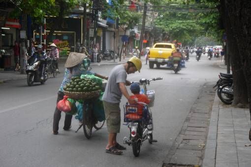Electric bike, push bike and oranges in Hanoi's Old Quarter
