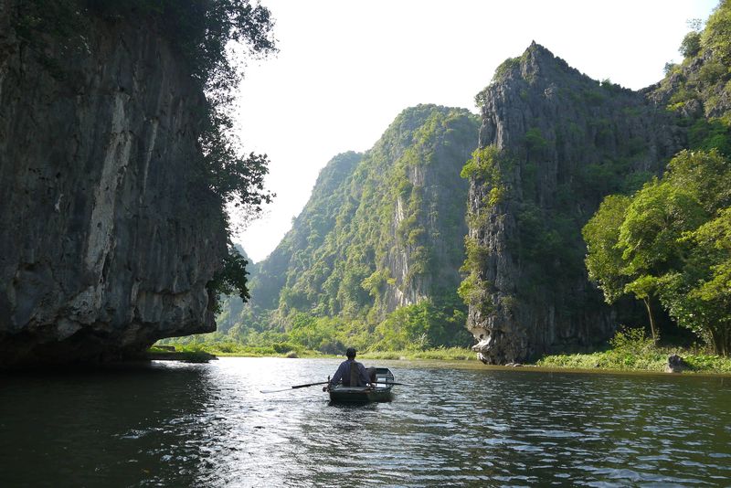 A boat floating down the river in Tam Coc