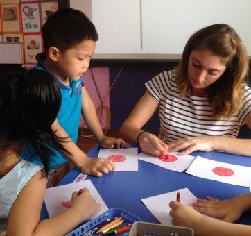 Hannah colouring with her Vietnamese students