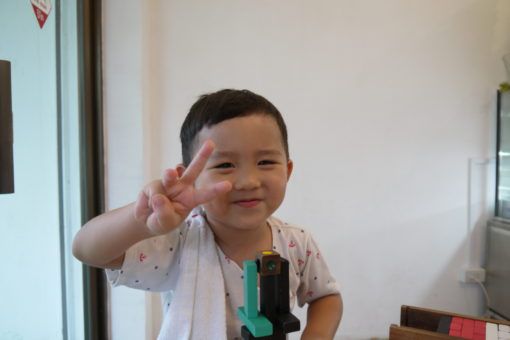 Thai Boy making a Peace Sign