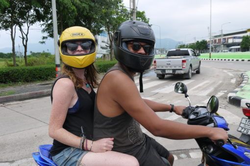 James and Sarah riding a motorbike in Chiang Mai