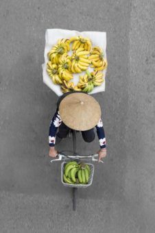 Aerial view of a Hanoi Street Vendor on a bike full of bananas 