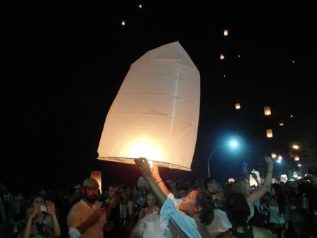 Girl releasing a lantern at Yi Peng festival 2016 in Chiang Mai, Thailand