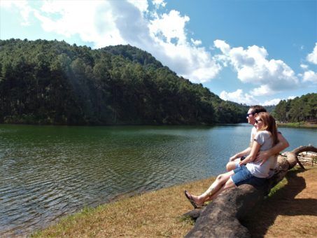 Us sitting on a log in Pang Ung reservoir, Northern Thailand