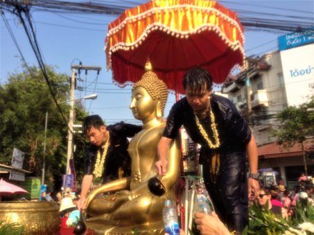 Buddhists blessing the Buddha statues for Songkran festival in Thailand