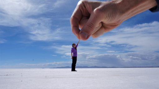 Salt Flats perspective photo - big hand picking up a small person