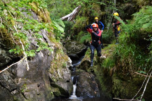Adventure activities Scotland: doing a cliff jump on a canyoning trip 