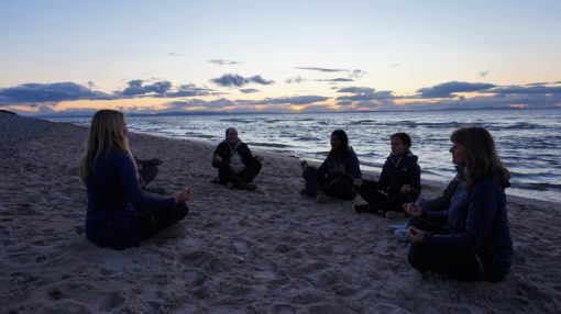 Group meditation on the beach at Findhorn Bay in Scotland 