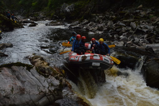 Raft going over rapids on the river Findhorn in Scotland