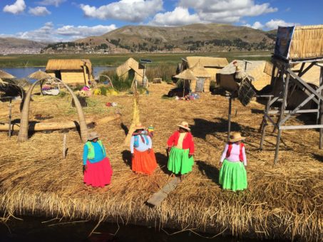 The brightly coloured clothes of the Uros women on the floating islands, Lake Titicaca Trip