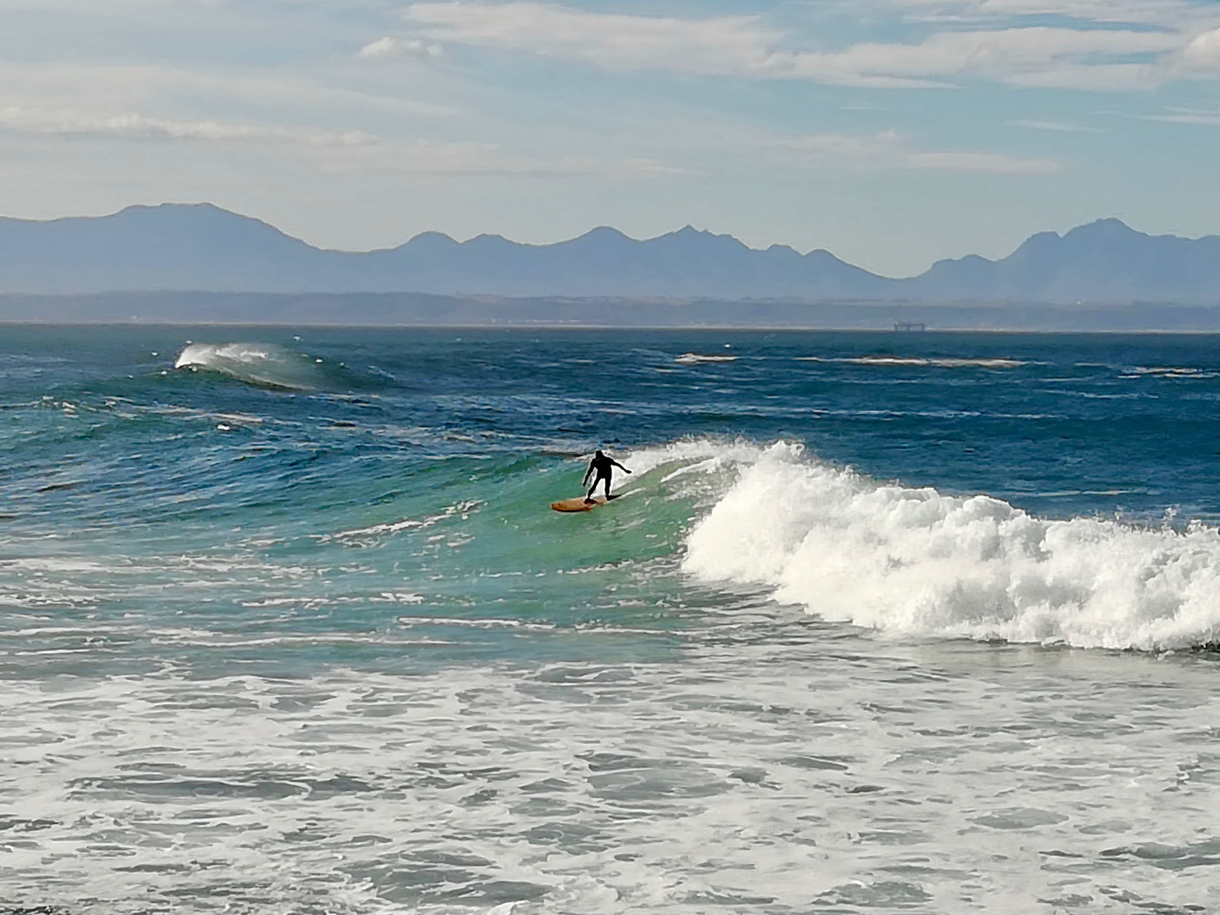 Surfer at Jeffrey's Bay on our Garden Route road trip itinerary, South Africa