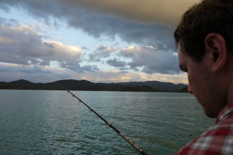 Andrew fishing at dusk in the Bay of Islands