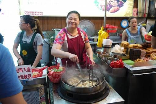 Woman cooking food in Taipei