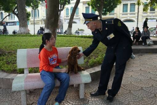 Police man and dog at Hoan Kiem Lake in Hanoi