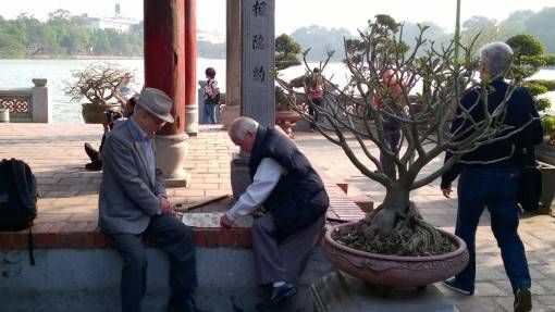 Men playing checkers at Ngoc Son Temple in Hanoi's Old Quarter