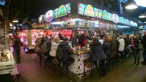 People eating at a restaurant in La Boqueria Market in Barcelona