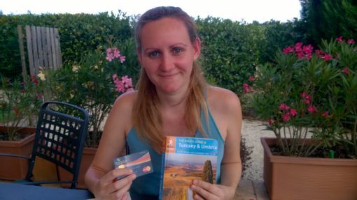 Amy with a WeSwap Card and Guide Book for Italy