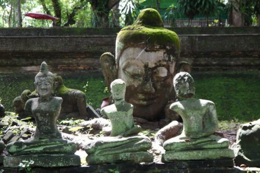 Stone Buddha Statues in a garden at Wat Umong Temple in Chiang Mai