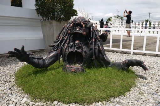 Predator statue rising from the ground at the White Temple