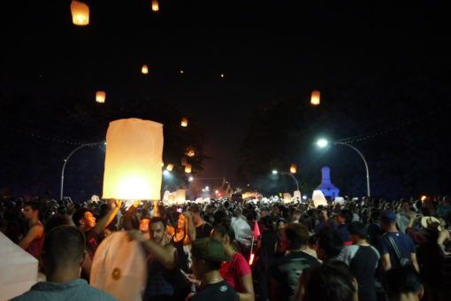 People releasing paper lanterns on Nawarat Bridge in Chiang Mai during the Yi Peng festival