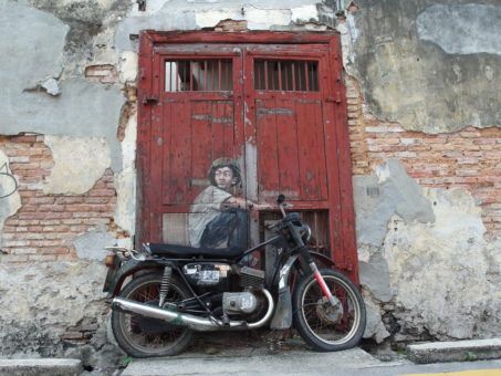 Boy on a motorbike street mural in Penang, Malaysia