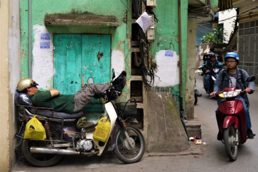 Vietnamese man napping on his motorbike