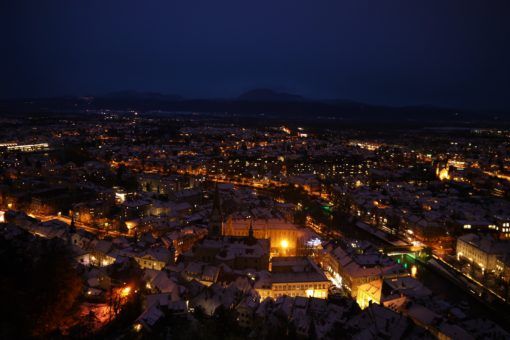 Aerial view of Ljubljana's snow-covered rooftops at night