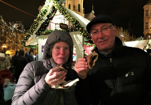 Andrew's mum and dad eating the trdelnik at the Prague Christmas Market