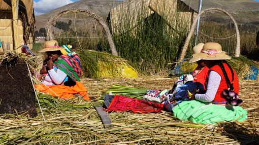 Neon clothed Uros women on the Uros floating Islands, Lake Titicaca