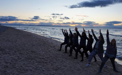 Yoga pose on the sand at Findhorn Bay, Scotland
