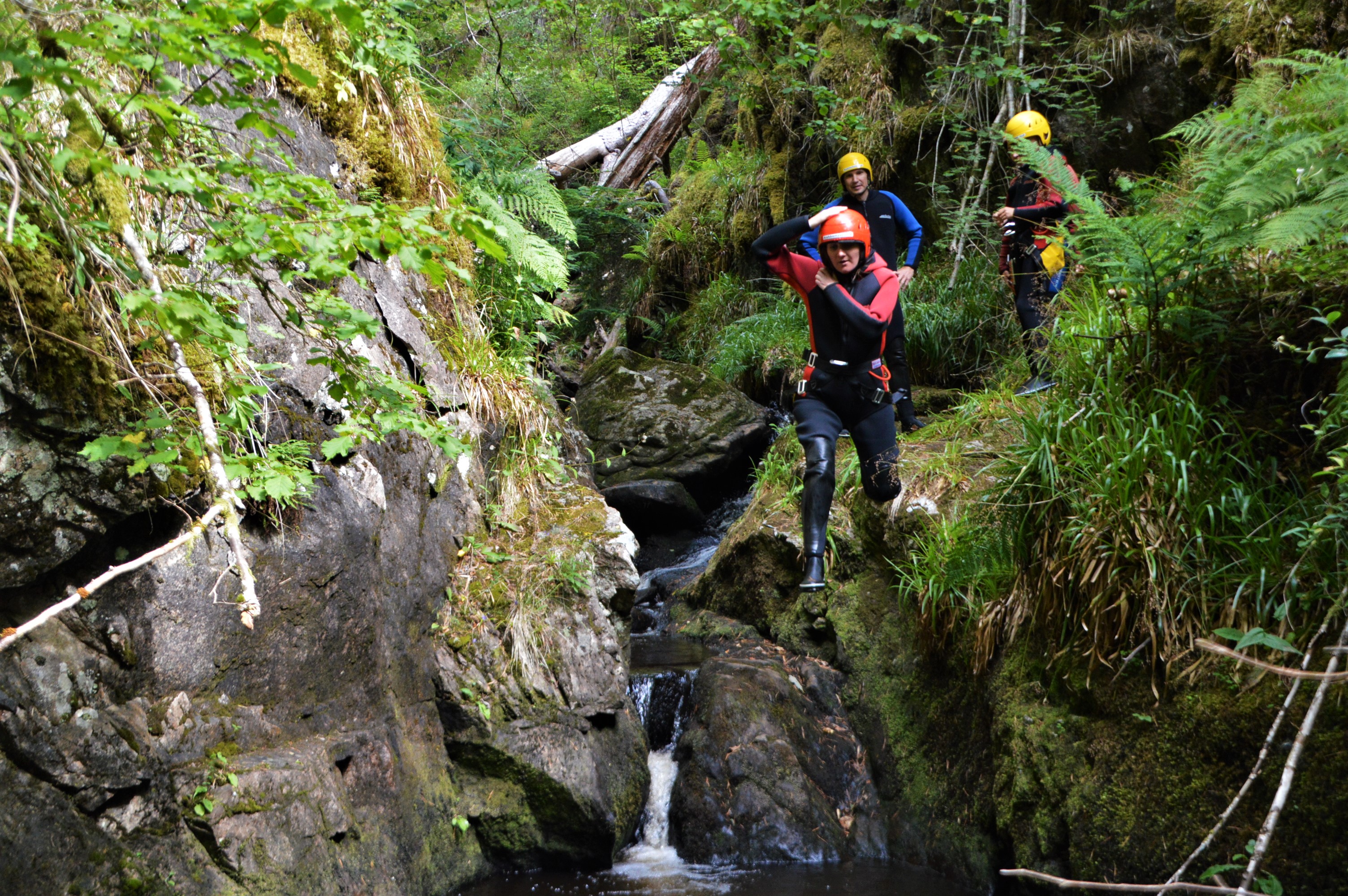 Doing a cliff jump on a canyoning trip in Scotland - Our Big Fat Travel ...