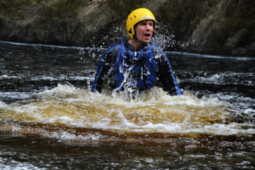 Andrew jumping into the river on a trip with ACE Adventures in Moray, Scotland
